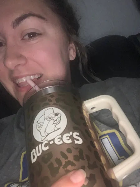 Customer sipping a tall pink Tavo LiquidCalm liquid calm drink in her kitchen.